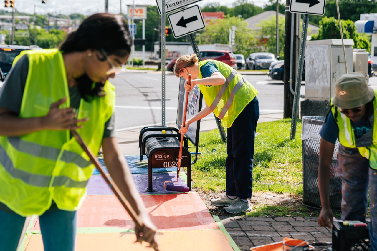 For her senior capstone, Nashville Big Picture High School senior Cydney Rugless-Thompson wanted to revamp a bus stop on Charlotte Pike. By painting a mural on the ground in front of the bus stop bench, Cydney hopes to create a more welcoming environment for people wanting to use public transportation on Charlotte Pike. As someone who waits at that exact bus stop to go to school with around 30 of her classmates multiple times per week, Cydney recognizes the importance of urban spaces and how they can be more welcoming for locals.